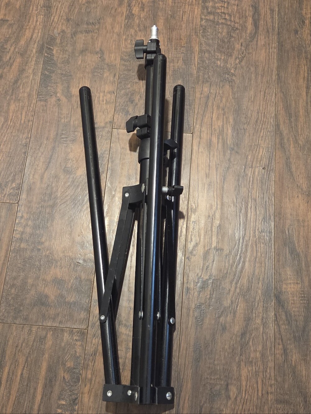 Folded black metal photography light stand Tripod